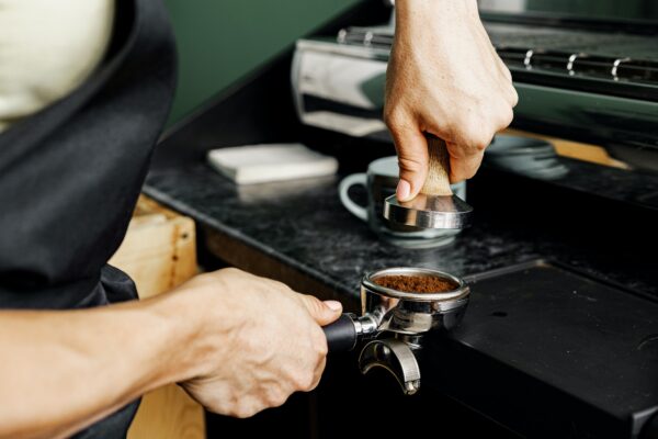 woman coffee shop worker preparing coffee